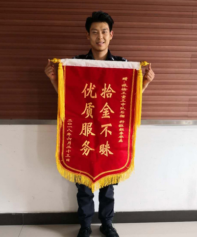 一面锦旗致敬拾金不昧安检员